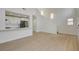 Spacious living room with kitchen view and staircase, creating an open and airy atmosphere at 56 Belle Ridge Ave, Las Vegas, NV 89123