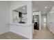 Bright living room with kitchen view and hallway, creating an open and airy atmosphere at 56 Belle Ridge Ave, Las Vegas, NV 89123