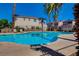 Outdoor community pool surrounded by palm trees and sun loungers at 56 Belle Ridge Ave, Las Vegas, NV 89123
