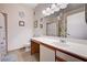 Well-lit bathroom with a long vanity, a large mirror, and a shower with decorative curtains at 5751 E Hacienda Ave # 154, Las Vegas, NV 89122