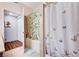 Bathroom featuring tiled floor and walls, bathtub, and a bright, decorative shower curtain at 5751 E Hacienda Ave # 154, Las Vegas, NV 89122
