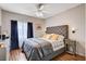 Bedroom with a ceiling fan, and a bed with upholstered headboard and wood-look floors at 5751 E Hacienda Ave # 154, Las Vegas, NV 89122