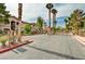 Community entrance with a gated entrance, mature trees, and landscaping at 5751 E Hacienda Ave # 154, Las Vegas, NV 89122