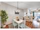 Bright dining area featuring a white table and light blue chairs with a modern chandelier at 5751 E Hacienda Ave # 154, Las Vegas, NV 89122