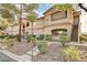 Two-story exterior of an apartment building with stairs and mature landscaping at 5751 E Hacienda Ave # 154, Las Vegas, NV 89122