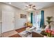 Cozy living room features wood floors, a gray sofa, and a sliding glass door for natural light at 5751 E Hacienda Ave # 154, Las Vegas, NV 89122