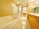 Bathroom with a large tub, a shower, and double sinks at 62 E Serene Ave # 115, Las Vegas, NV 89123