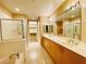 Well-lit bathroom with double sinks and a large mirror at 62 E Serene Ave # 115, Las Vegas, NV 89123