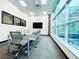 Stylish conference room with glass table, ergonomic chairs, and a wall-mounted television at 62 E Serene Ave # 115, Las Vegas, NV 89123