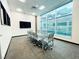 Bright conference room features modern glass table, comfortable seating and large windows at 62 E Serene Ave # 115, Las Vegas, NV 89123