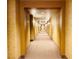 An extra long hallway with carpeting and patterned wallpaper at 62 E Serene Ave # 115, Las Vegas, NV 89123