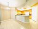 Open-concept kitchen featuring light wood cabinetry and a breakfast bar at 62 E Serene Ave # 115, Las Vegas, NV 89123