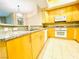 Features of this kitchen includes granite countertops, wood cabinets and tile flooring at 62 E Serene Ave # 115, Las Vegas, NV 89123