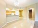 Open kitchen featuring light wood cabinets, breakfast bar, and tile flooring at 62 E Serene Ave # 115, Las Vegas, NV 89123