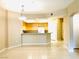 View of the open kitchen with breakfast bar and light wood cabinetry at 62 E Serene Ave # 115, Las Vegas, NV 89123