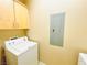 A basic laundry room featuring a washer, dryer and cabinets for storage at 62 E Serene Ave # 115, Las Vegas, NV 89123