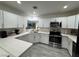 Well-lit kitchen boasts stainless steel appliances, stylish countertops, and white cabinets, creating a desirable culinary space at 621 S 9Th St, Las Vegas, NV 89101