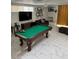 Spacious living room features a pool table, unique decor, fireplace, and large windows, perfect for relaxation and entertainment at 621 S 9Th St, Las Vegas, NV 89101