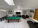 The living room features a pool table, lots of seating, modern decor, fireplace, and great natural light at 621 S 9Th St, Las Vegas, NV 89101