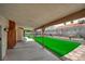 Spacious covered patio with an artificial grass lawn and block wall, ideal for outdoor living at 6508 Peppermill Dr, Las Vegas, NV 89146