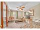 Bedroom with two beds, a ceiling fan, a writing desk, and neutral carpet at 6508 Peppermill Dr, Las Vegas, NV 89146
