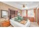 Bedroom featuring a queen size bed with multiple pillows, bedside tables, and a vintage style ceiling fan at 6508 Peppermill Dr, Las Vegas, NV 89146