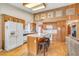 Well-equipped kitchen with wooden cabinets, an island with bar seating, and modern appliances at 6508 Peppermill Dr, Las Vegas, NV 89146