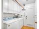 Bright laundry room with washer, dryer, storage cabinets, and convenient access to the house at 6508 Peppermill Dr, Las Vegas, NV 89146