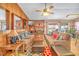 Cozy living room with comfortable sofas, a stone fireplace, and a ceiling fan at 6508 Peppermill Dr, Las Vegas, NV 89146