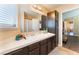 Bathroom with dual sinks, dark wood vanity, and a large framed mirror at 6529 Hartwood Rd, Las Vegas, NV 89108
