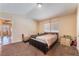 Bedroom with neutral walls, window with blinds, and framed wall art at 6529 Hartwood Rd, Las Vegas, NV 89108