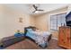 Comfortable bedroom with a bed, window, ceiling fan and ample natural light at 6529 Hartwood Rd, Las Vegas, NV 89108