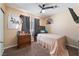 Cozy bedroom features carpeted floors, window with blinds, and ceiling fan at 6529 Hartwood Rd, Las Vegas, NV 89108