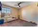 A spacious bedroom with a ceiling fan and a window with outdoor views at 6529 Hartwood Rd, Las Vegas, NV 89108