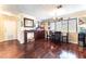 Open dining room with dark hardwood floors, modern lighting, and a full dining set at 6529 Hartwood Rd, Las Vegas, NV 89108