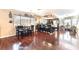 Open dining room featuring hardwood floors, modern lighting, and stylish black dining set at 6529 Hartwood Rd, Las Vegas, NV 89108