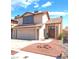 Charming two-story home featuring a tile roof, attached garage, and low maintenance front yard at 6529 Hartwood Rd, Las Vegas, NV 89108