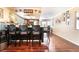 Eat-in kitchen featuring breakfast bar, dark wood cabinets, stainless steel appliances, and hardwood floors at 6529 Hartwood Rd, Las Vegas, NV 89108
