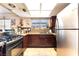 Bright kitchen featuring stainless steel appliances, granite countertops, and custom wood cabinets at 6529 Hartwood Rd, Las Vegas, NV 89108