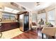 Well-lit kitchen with granite countertops, wooden cabinets, stainless steel refrigerator, and tile floors at 6529 Hartwood Rd, Las Vegas, NV 89108