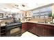 Spacious kitchen with granite countertops, stainless steel appliances, and tile flooring at 6529 Hartwood Rd, Las Vegas, NV 89108