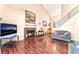 Open living room boasts rich hardwood floors, fireplace, and a modern staircase at 6529 Hartwood Rd, Las Vegas, NV 89108