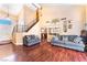 Stunning living room with high ceilings, hardwood floors, elegant staircase, and neutral color palette at 6529 Hartwood Rd, Las Vegas, NV 89108