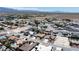 An aerial view displays a neighborhood with desert landscaping and mountain views in the distance at 6841 Longmeadow Dr, Pahrump, NV 89061