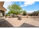 Backyard featuring drought resistant landscaping, a brick patio, and a built-in barbecue at 6841 Longmeadow Dr, Pahrump, NV 89061