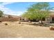 Expansive backyard with desert landscaping and a covered patio, providing ample space for outdoor activities at 6841 Longmeadow Dr, Pahrump, NV 89061