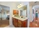 Bathroom vanity features wood cabinets, marble countertops, and a large mirror at 6841 Longmeadow Dr, Pahrump, NV 89061