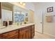 Classic bathroom vanity featuring wood cabinets, a white countertop, and a large mirror at 6841 Longmeadow Dr, Pahrump, NV 89061