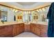 Bathroom featuring an ample vanity, multiple sinks, and modern lighting fixtures at 6841 Longmeadow Dr, Pahrump, NV 89061