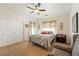 Comfortable bedroom featuring a ceiling fan, neutral decor, and soft natural light for a cozy ambiance at 6841 Longmeadow Dr, Pahrump, NV 89061